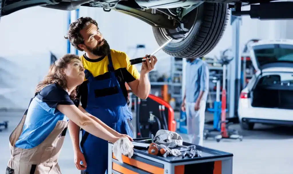 Technicians working on a car in an auto repair shop