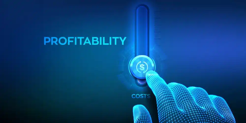 A digital illustration of a futuristic, glowing blue interface showing a hand adjusting a financial gauge from "COSTS" to "PROFITABILITY," with a dollar sign in the center. The image symbolizes financial growth and business success.