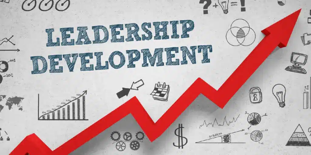 A red upward arrow with the words "Leadership Development" surrounded by business and strategy-related doodles.