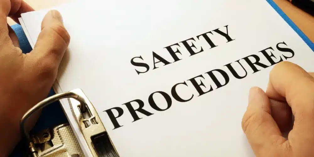 This image features a binder or document labeled "SAFETY PROCEDURES," emphasizing the importance of workplace safety, compliance, and risk management. It is well-suited for content related to occupational safety, training materials, or guidelines for maintaining a secure work environment.